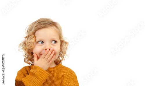 Shy funny child covering his mouth