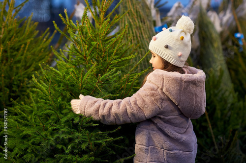 Quadro em tela winter holidays and people concept - happy smiling little girl choosing christma