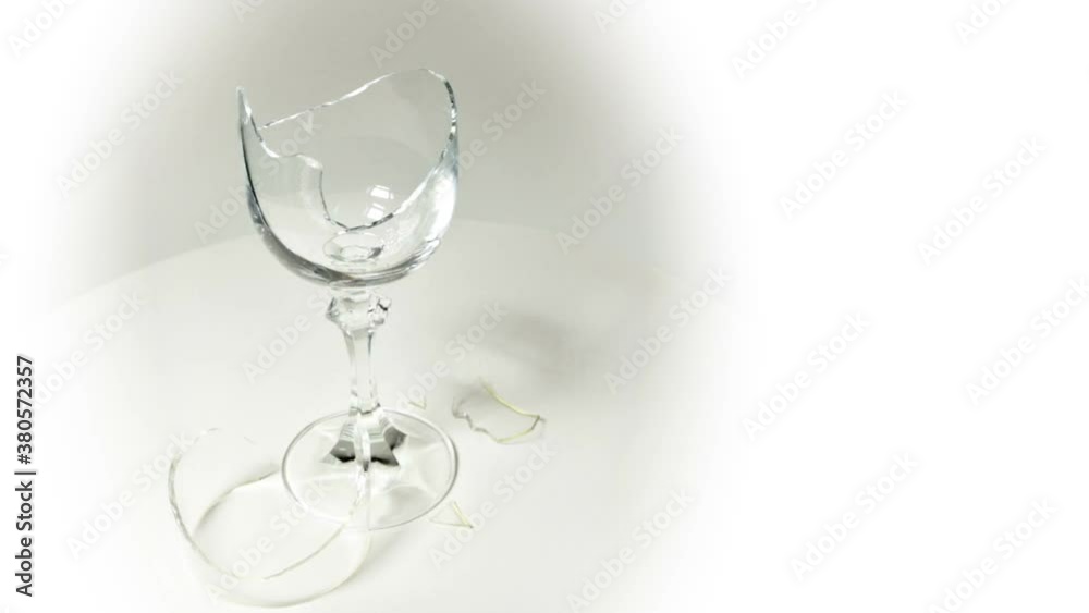 A broken crystal glass in rotation on a white background.