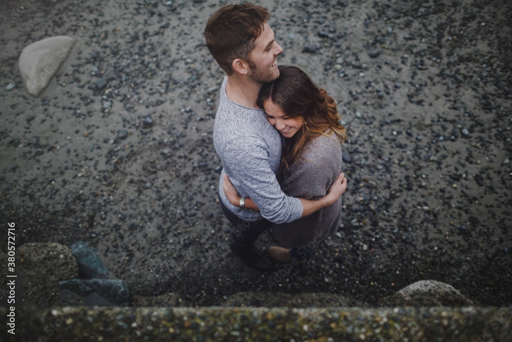 Young happy couple hugging each other outside with affection Young happy couple hugging each other outside with affection