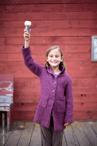 Girl with ice cream in statue of liberty pose photo