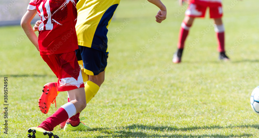 Boys play soccer sports field
