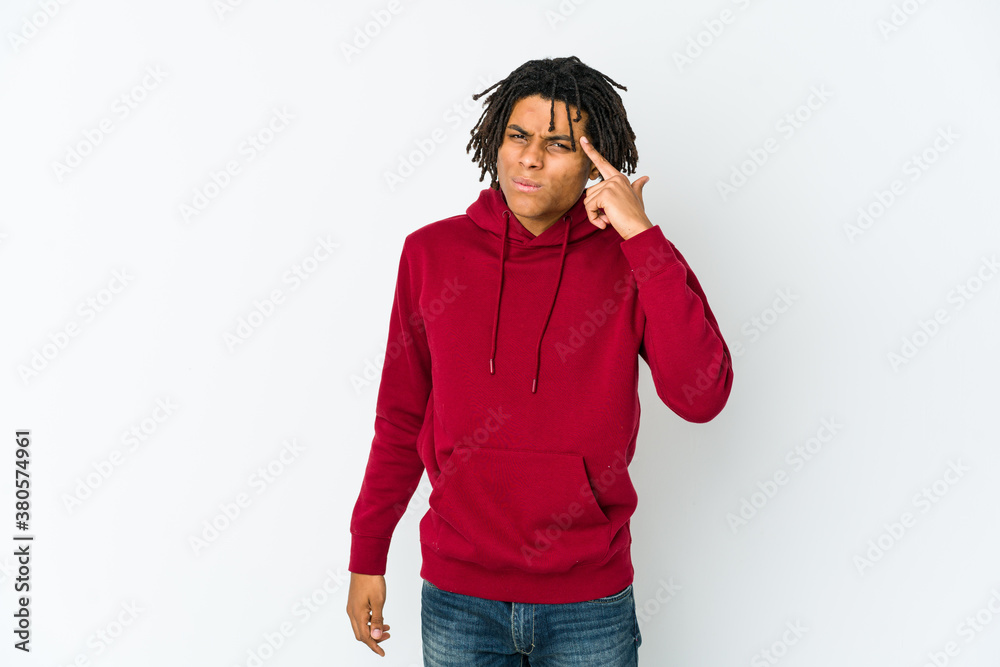 Young african american rasta man pointing temple with finger, thinking, focused on a task. Young african american rasta man pointing temple with finger, thinking, focused on a task.