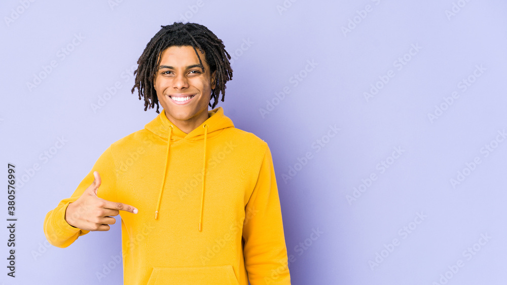 Young african american rasta man person pointing by hand to a shirt copy space, proud and confident Young african american rasta man person pointing by hand to a shirt copy space, proud and confident