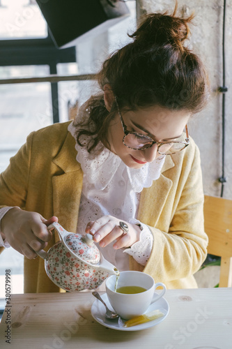 Woman Pouring Green Tea at the Cafe photo