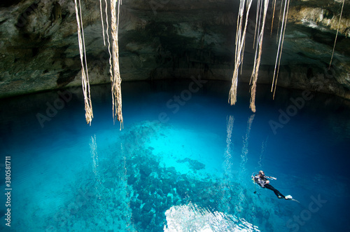 Diver in caved cenote photo