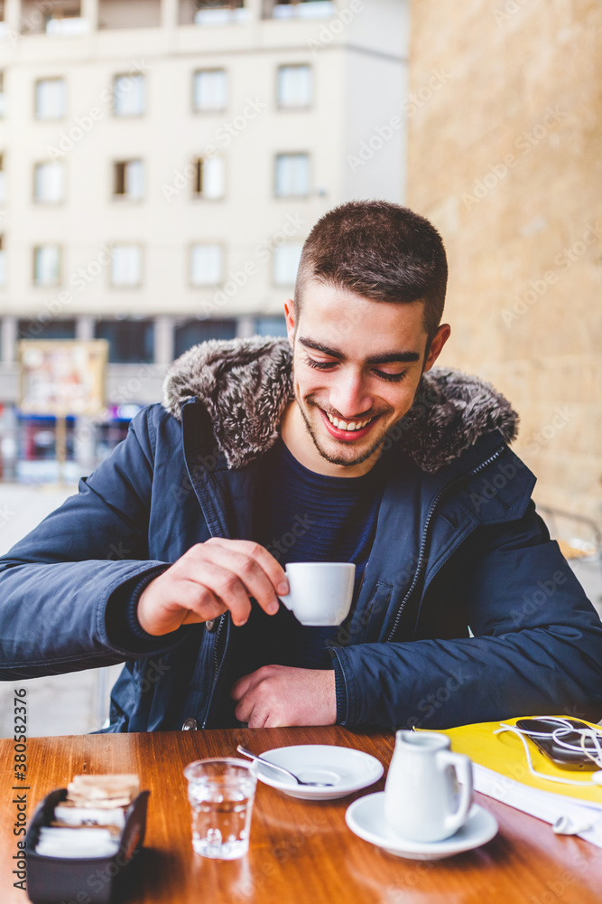 Happy Young Man Having an Italian Espresso during the Cold Season Happy Young Man Having an Italian Espresso during the Cold Season