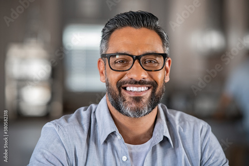 Smiling indian man looking at camera photo