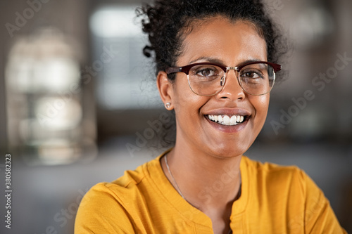 Happy black woman looking at camera with eyeglasses