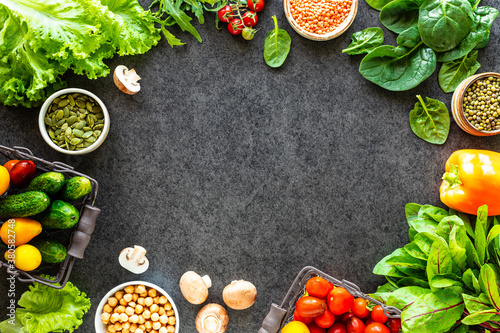 Healthy food background. Autumn fresh vegetables on dark stone background with copy space, top view