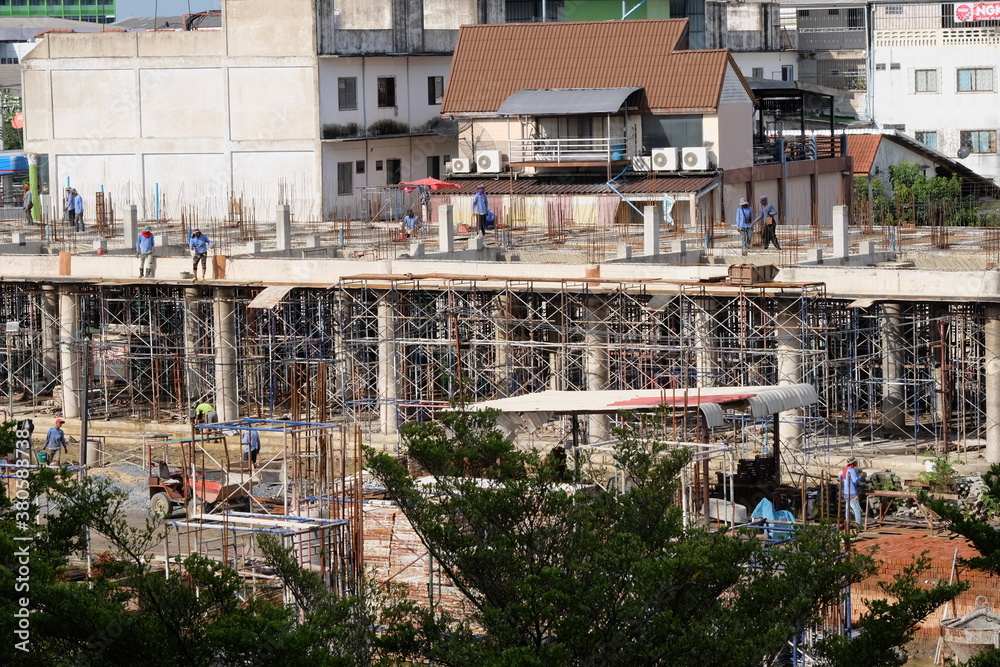 construction workers working on large buildings construction workers working on large buildings
