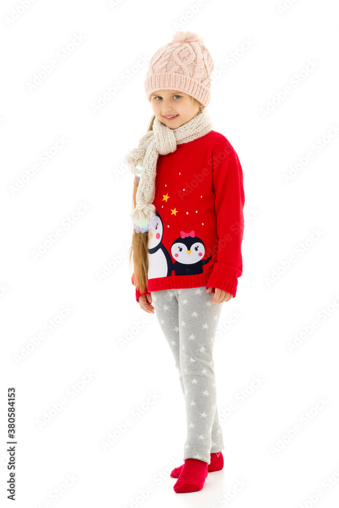 Little girl in a hat and scarf.Isolated on white background. Little girl in a hat and scarf.Isolated on white background.