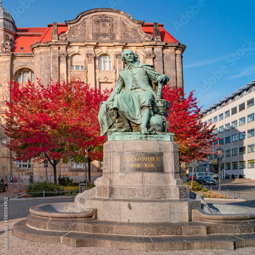 Statue of great scientist Otto von Guericke in red and golden Autumn colors in historical downtown of Magdeburg Germany, at sunny day and blue sky, closeup, details..