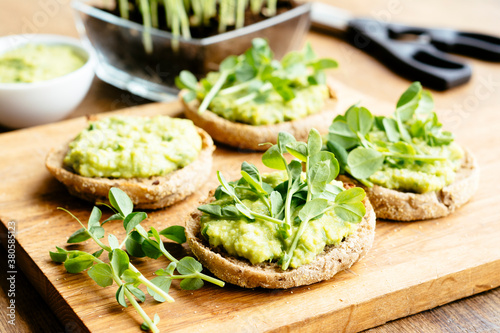 Muffins with an avocado/fava bean mash and pea sprouts