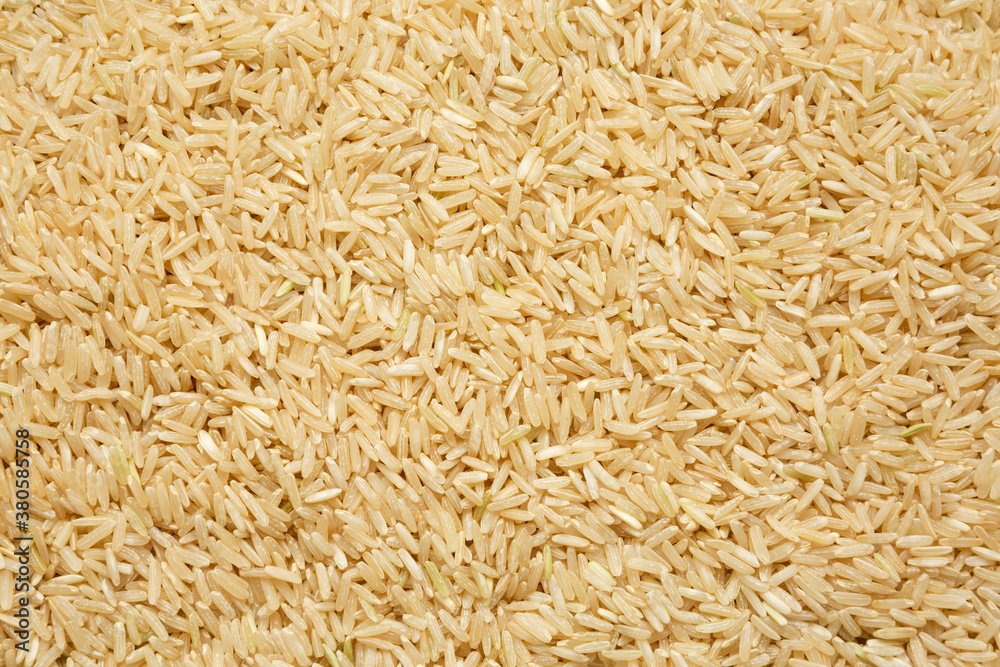 Dry Brown Rice background, top view. Overhead, from above, flat lay. Dry Brown Rice background, top view. Overhead, from above, flat lay.