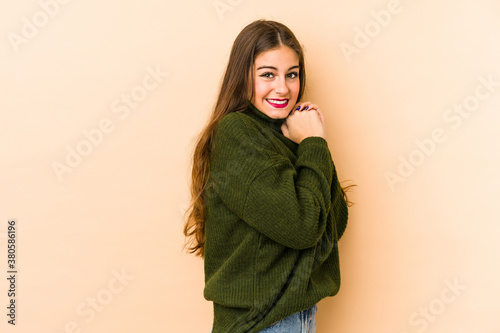 Young caucasian woman isolated en beige background scared and afraid. © Asier