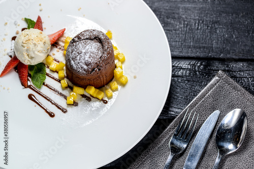 dessert chocolate fondat with ice cream and strawberries on a white plate
 photo