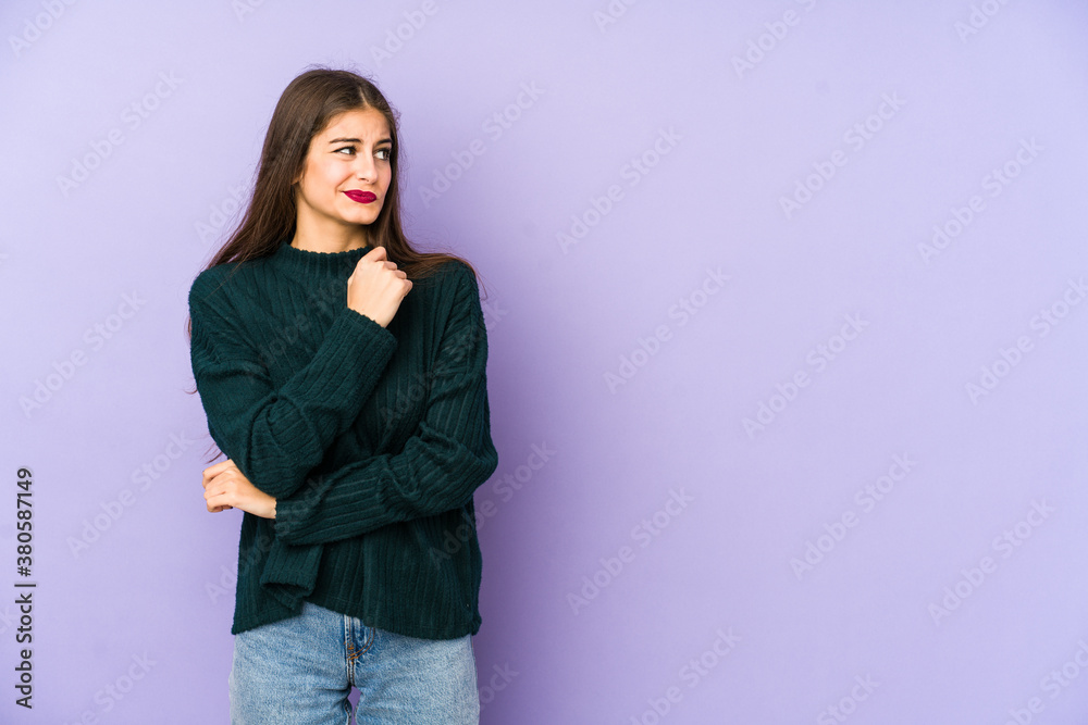Young caucasian woman isolated on purple background confused, feels doubtful and unsure. Young caucasian woman isolated on purple background confused, feels doubtful and unsure.