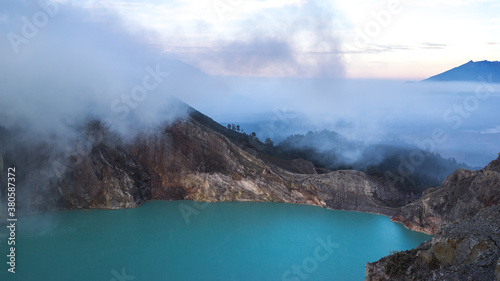 Kawah Ijien volcano. Beautiful toxic sulphur lake, East Java Indonesia. Misty sunrise in the moutains photo