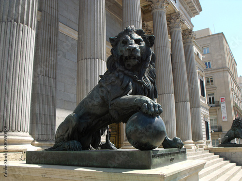 Madrid, Spain, August 19, 2015: Cast iron lion on the entrance stairs to the Congress of Deputies. Madrid
