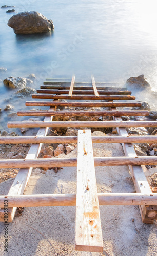 Wooden gangway into the sea photo