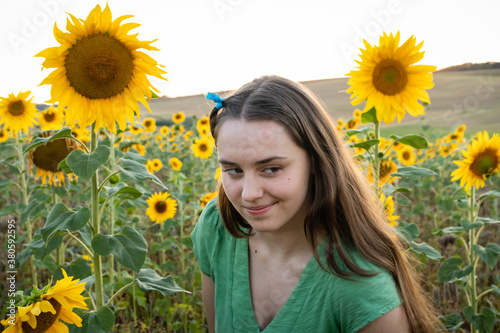 Fifteen year old teenage girl in a sunflower field near Potzbach, Germany.  photo