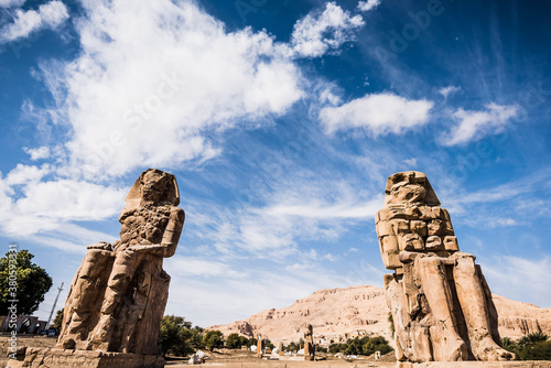 The Colossi of Memnon are two giant stone statues of Pharaoh Amenhotep III. Luxor, West Bank, Egypt photo