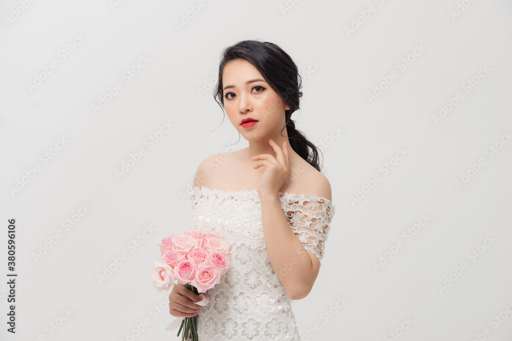 Fashion portrait of elegant woman with rose flower bouquet over white background. Fashion portrait of elegant woman with rose flower bouquet over white background.