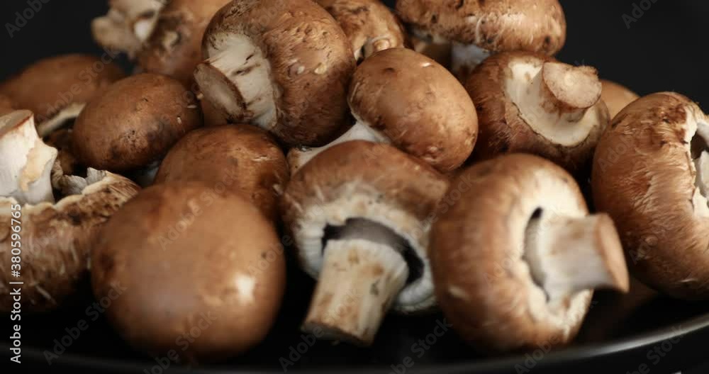 Fresh Raw Royal Champignon Mushrooms Rotating on black background Fresh Raw Royal Champignon Mushrooms Rotating on black background