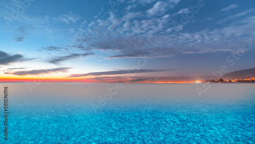 Long exposure photo of  Alanya beach with blue gravel at sunset © muratart