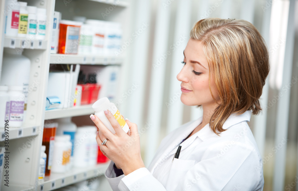 Pharmacy: Pharmacist Reading Prescription Label Pharmacy: Pharmacist Reading Prescription Label
