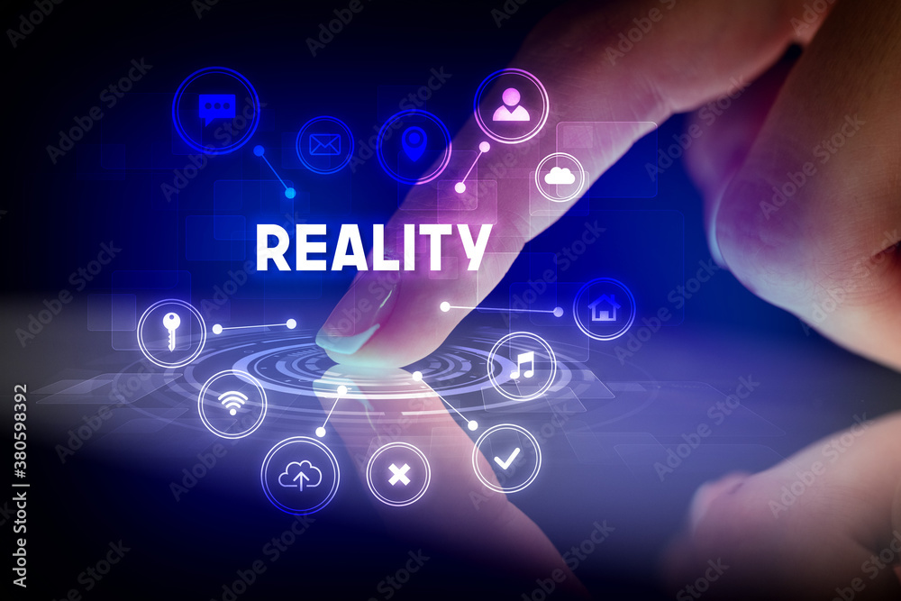 Finger touching tablet with web technology icons and REALITY inscription, web technology concept Finger touching tablet with web technology icons and REALITY inscription, web technology concept