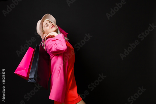Shopping woman holding bags, isolated on black background. black friday concept