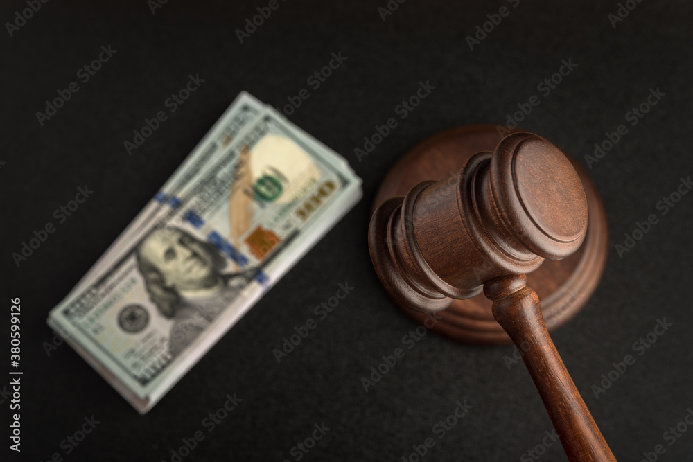 Wooden Judges gavel and bundles of dollars. Corrupt court. bribery in legislation