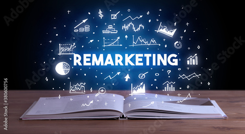 REMARKETING inscription coming out from an open book, business concept © ra2 studio
