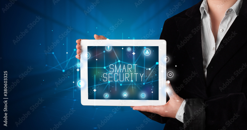 Young business person working on tablet and shows the digital sign: SMART SECURITY Young business person working on tablet and shows the digital sign: SMART SECURITY