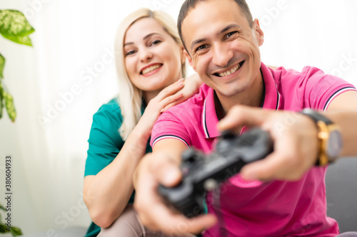 Couple playing video games at home