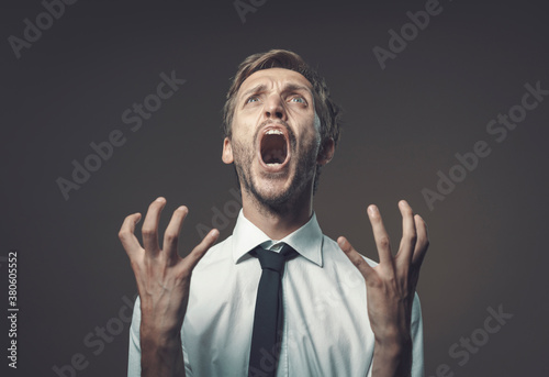 Angry stressed man shouting out loud