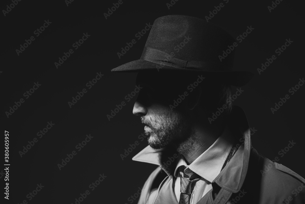 Noir film detective posing in the dark