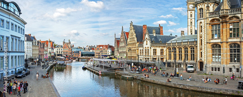 Ghent, Belgium: panoramic view on canal boats and many visitors at Graslei and Korenlei, famous for their historic facades. © Roel