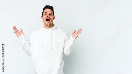 Young caucasian man isolated on white background surprised and shocked.