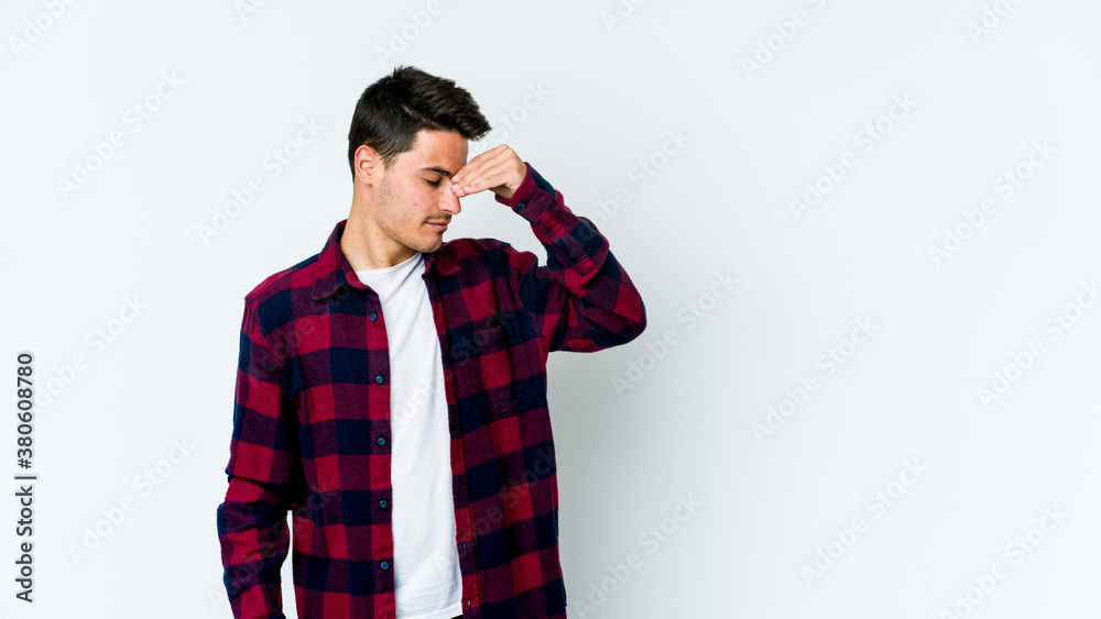 Young caucasian man isolated on white background having a head ache, touching front of the face. Young caucasian man isolated on white background having a head ache, touching front of the face.