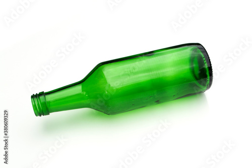 Green glass bottle on white background.