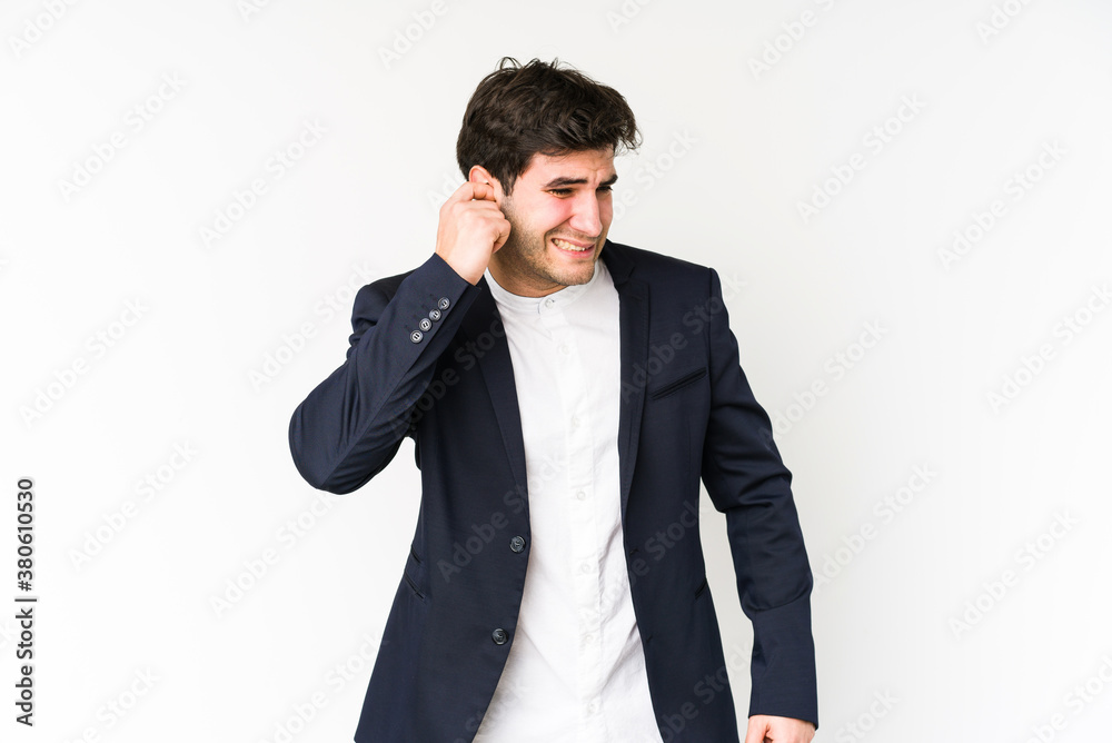 Young business man isolated on white background covering ears with hands. Young business man isolated on white background covering ears with hands.