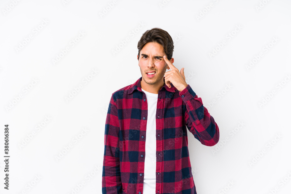 Young caucasian man posing in a pink background isolated showing a disappointment gesture with forefinger. Young caucasian man posing in a pink background isolated showing a disappointment gesture with forefinger.