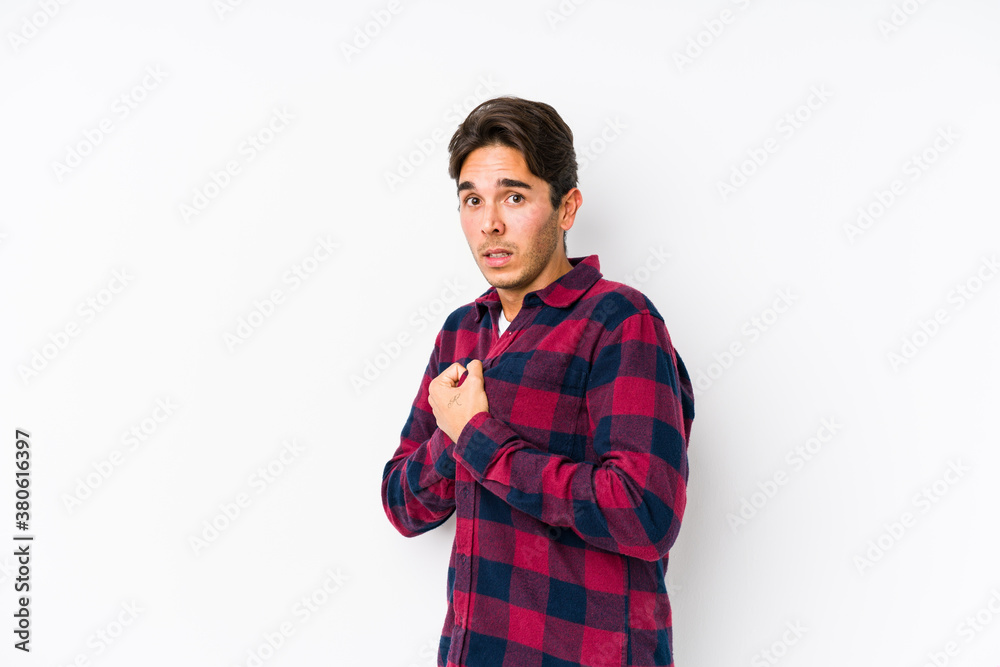 Young caucasian man posing in a pink background isolated scared and afraid.