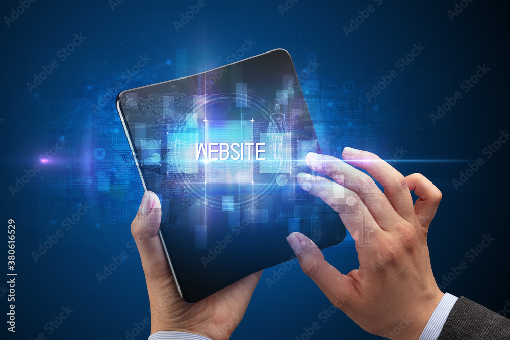 Businessman holding a foldable smartphone with WEBSITE inscription, new technology concept Businessman holding a foldable smartphone with WEBSITE inscription, new technology concept
