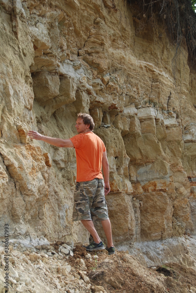 A young man explores rock delamination