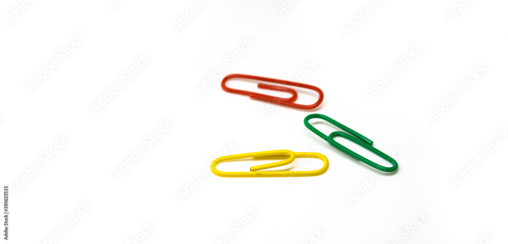Set of stationery multicolored paper clips on white isolated background