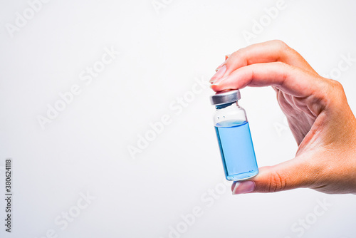A woman's hand holds an medical vial or ampoule. Vaccine. The ampoule with the medicine. Medication for injection.